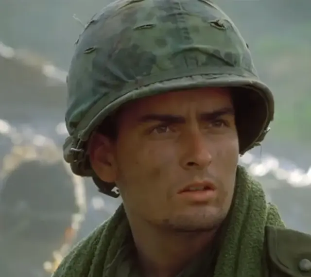 Charlie Sheen w wojskowym hełmie, jak w jego słynnych **filmach, serialach i programach**.