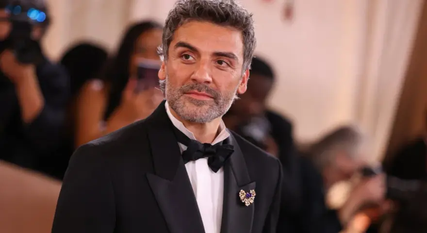 Oscar Isaac w eleganckim smokingu, gotowy na premierę swoich najnowszych filmów, seriali i programów.